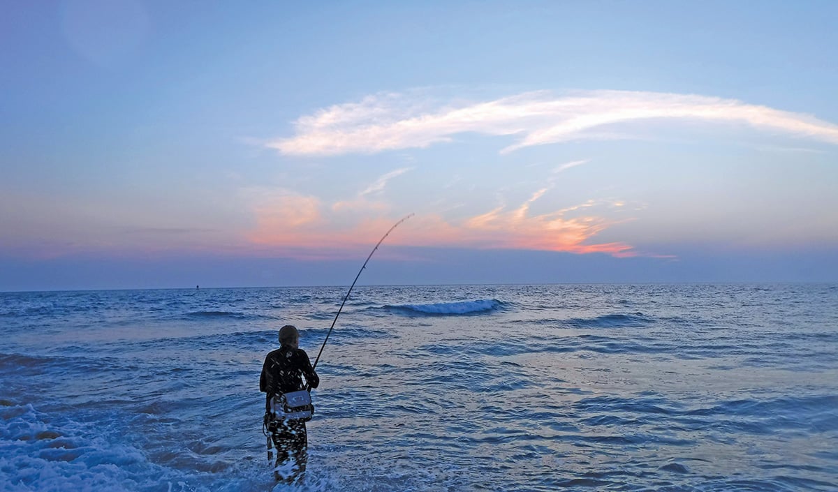 Fly-fisherman Waiting With Fishing Pole On Shoulder Stock Photo