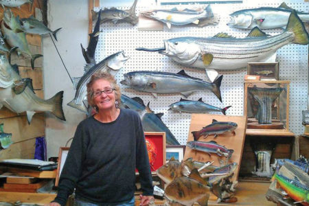 Janet Messineo smiling inside her taxidermy studio