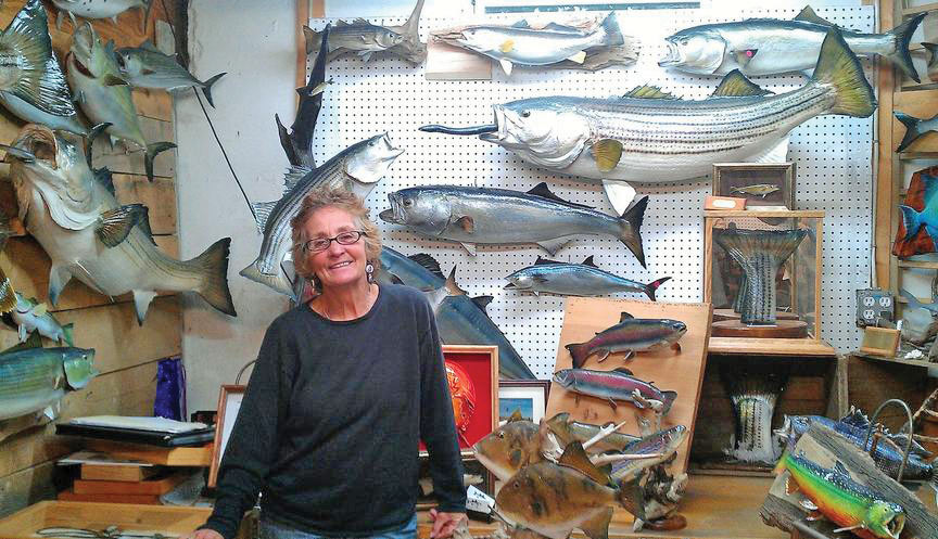 Janet Messineo smiling inside her taxidermy studio