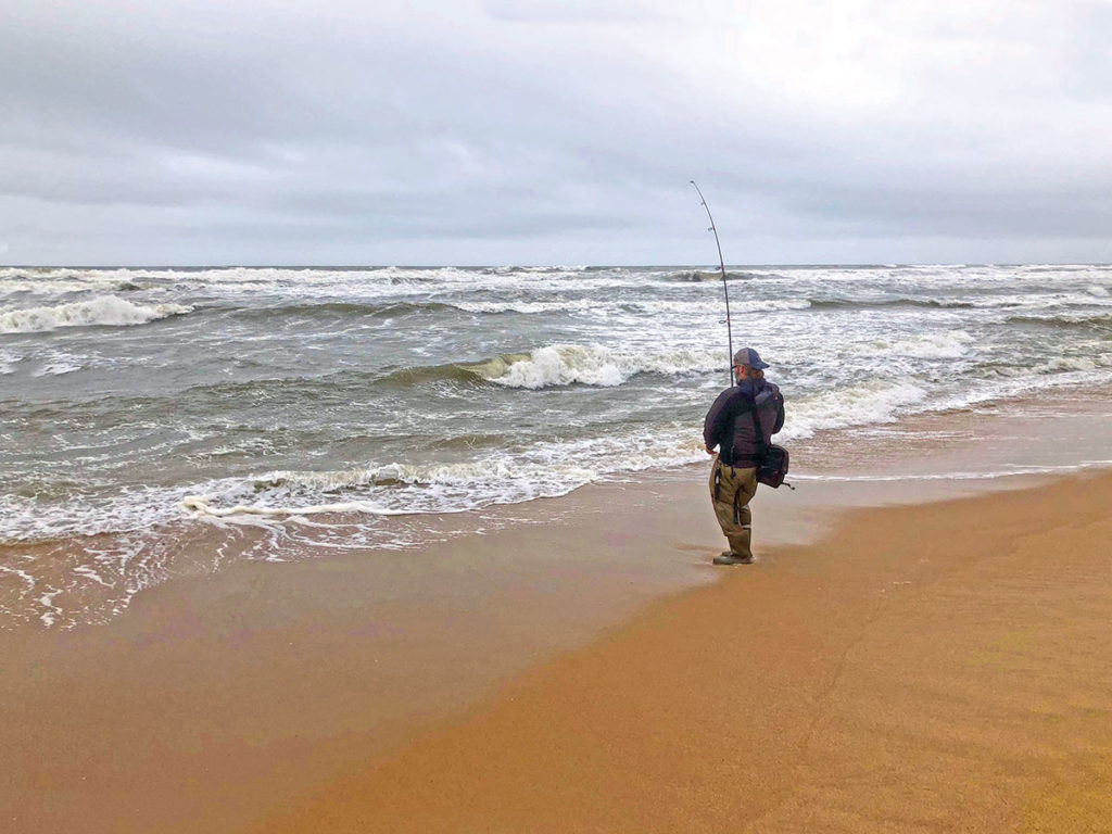 Man on the shore fishing