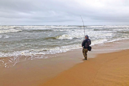 Man on the shore fishing