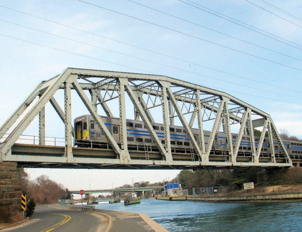 Train passes on a bridge over a canal