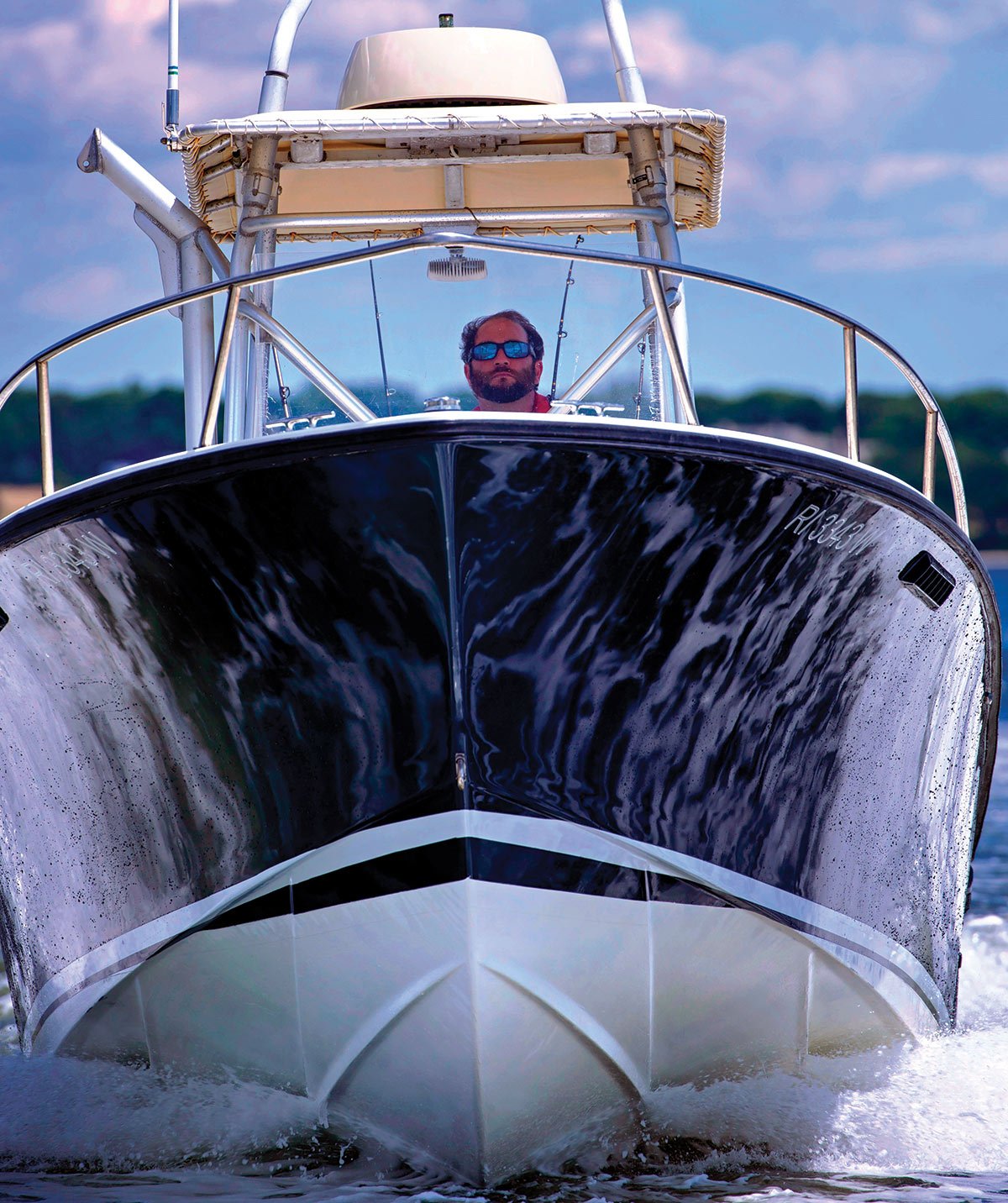 front view of boat with the captain in water