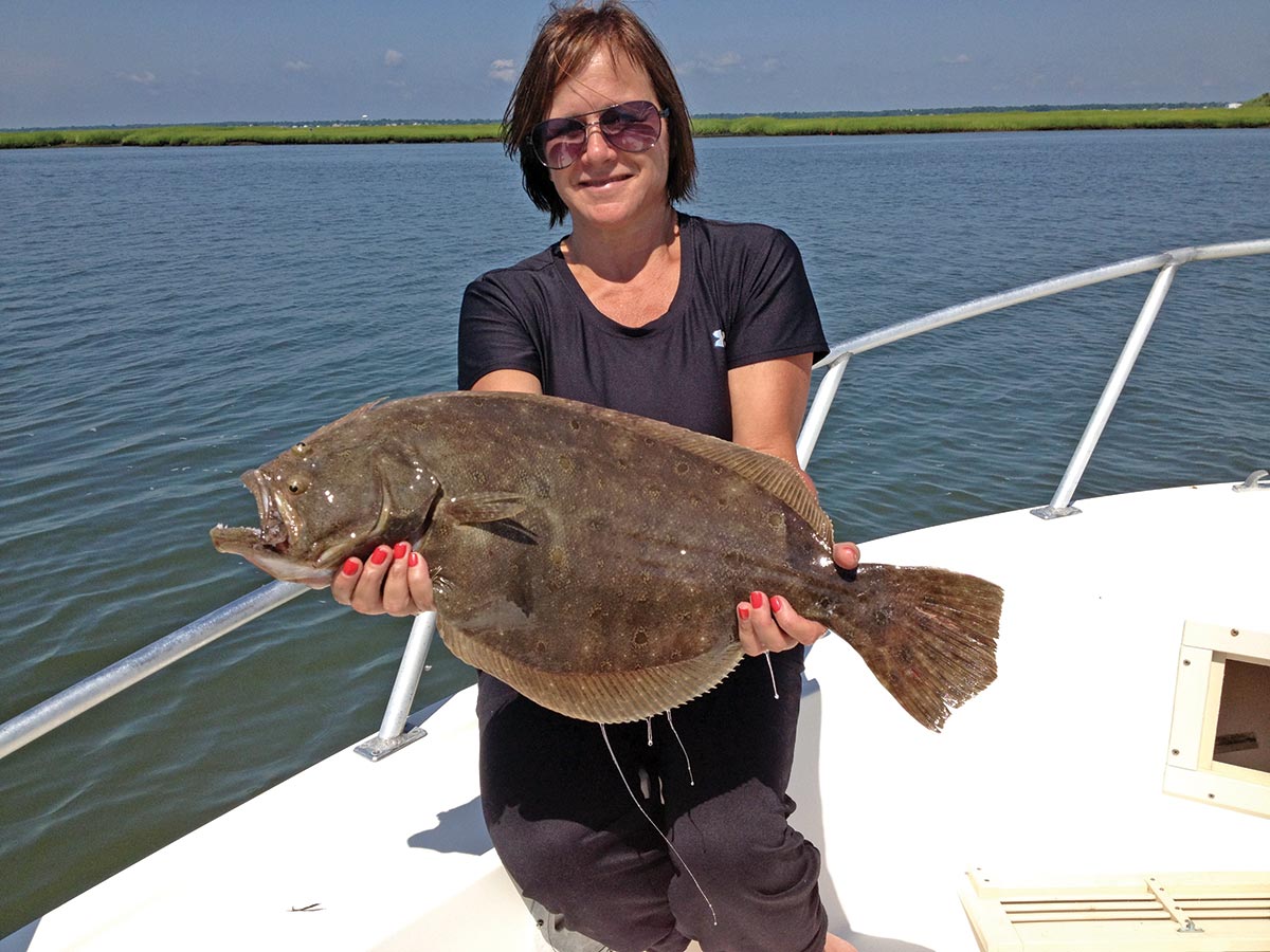Kim Mihalic showing a huge summer flounder