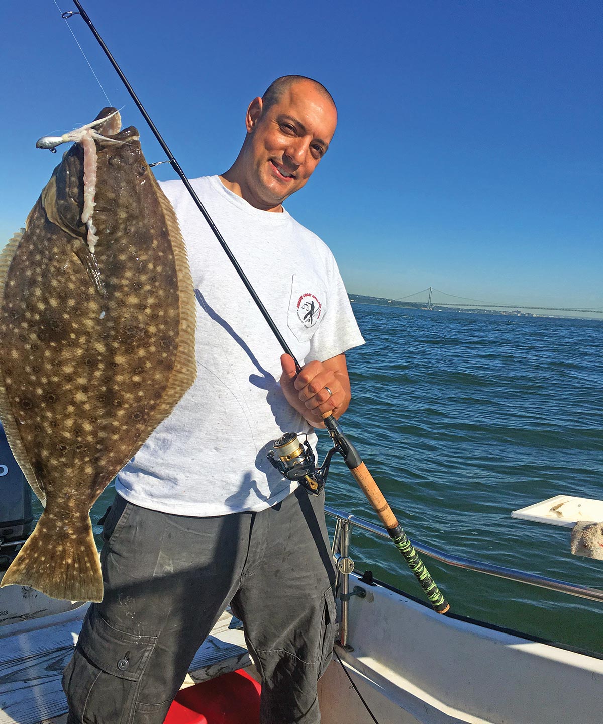 Capt. Austin Perill shows off a big fluke fish 