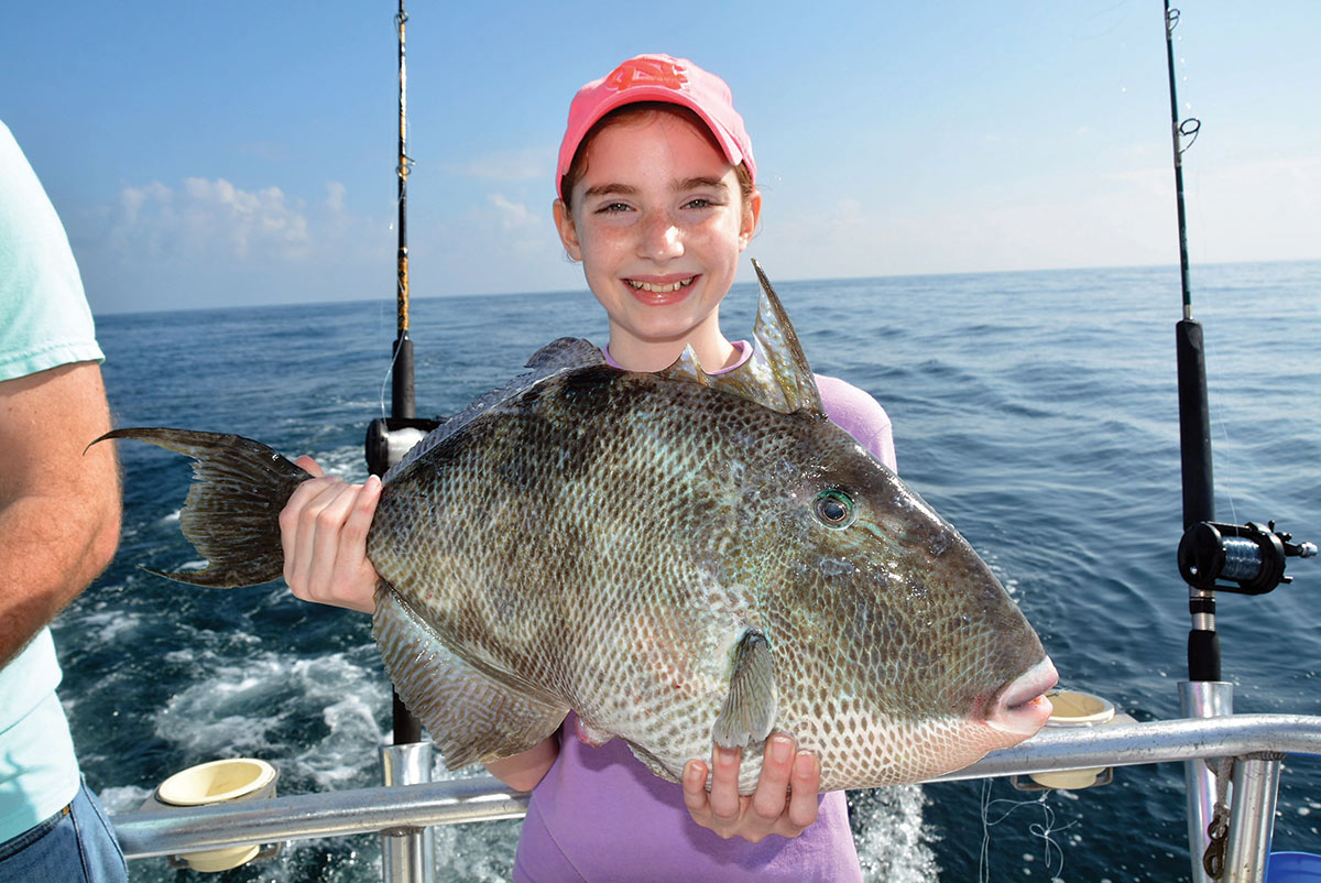 Girl holding a triggerfish