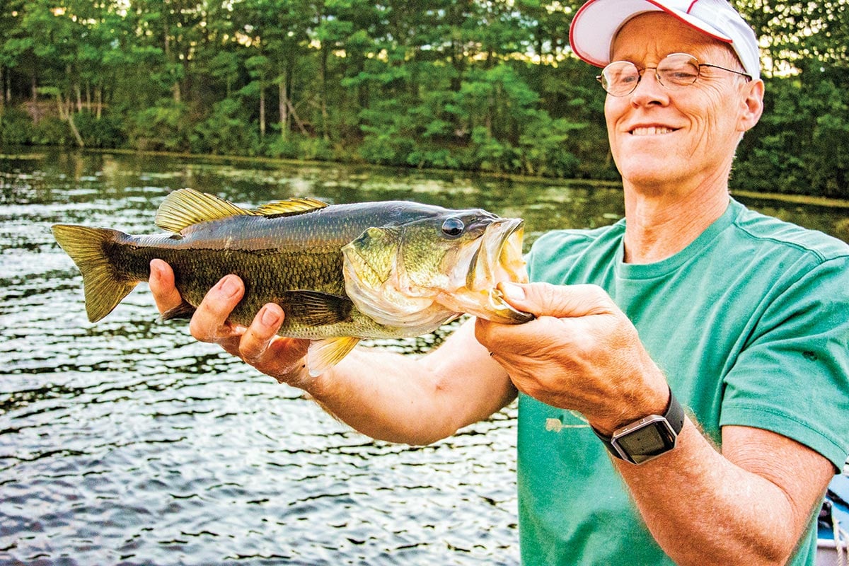 Man holding up a 4-pounder bucketmouth bass