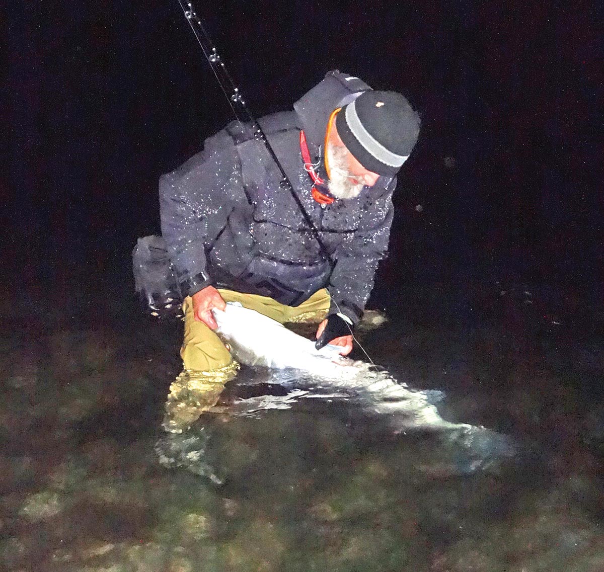 Man holding a fish caught by efficient casting