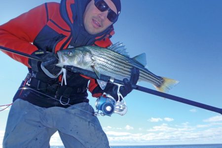 Man holding up a fish and a tsunami saltx