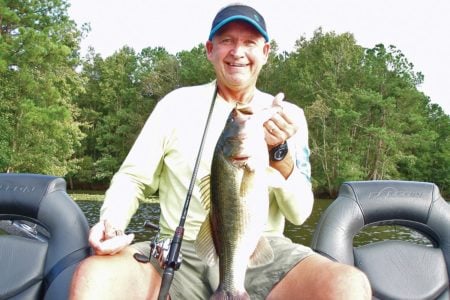 Tom Melton shows off a fat largemouth that was feeding on baitfish