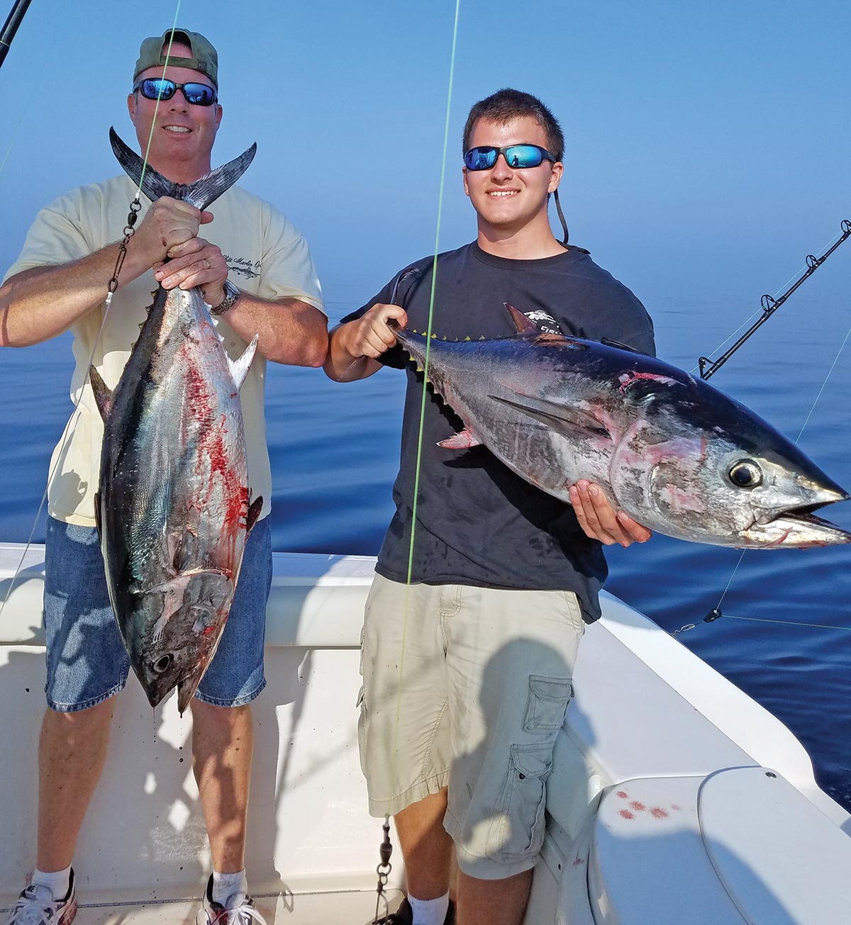 Two men showing off their fish