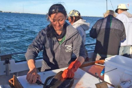 Deena Lippman, mate on the Shinnecock Star, puts the fillet knife to a nice fluke.