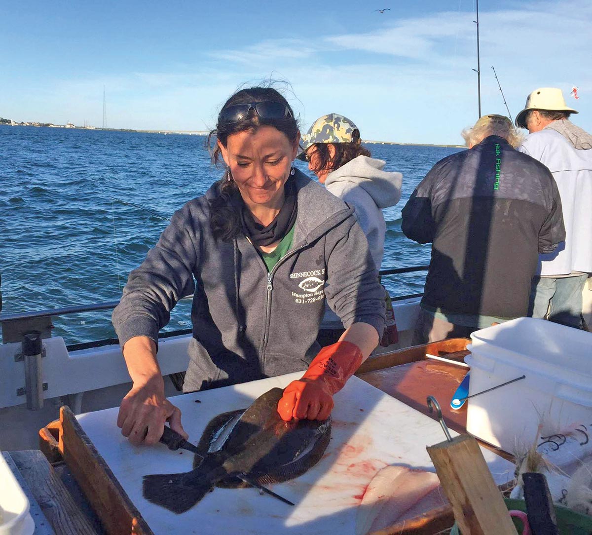 Deena Lippman, mate on the Shinnecock Star, puts the fillet knife to a nice fluke. 