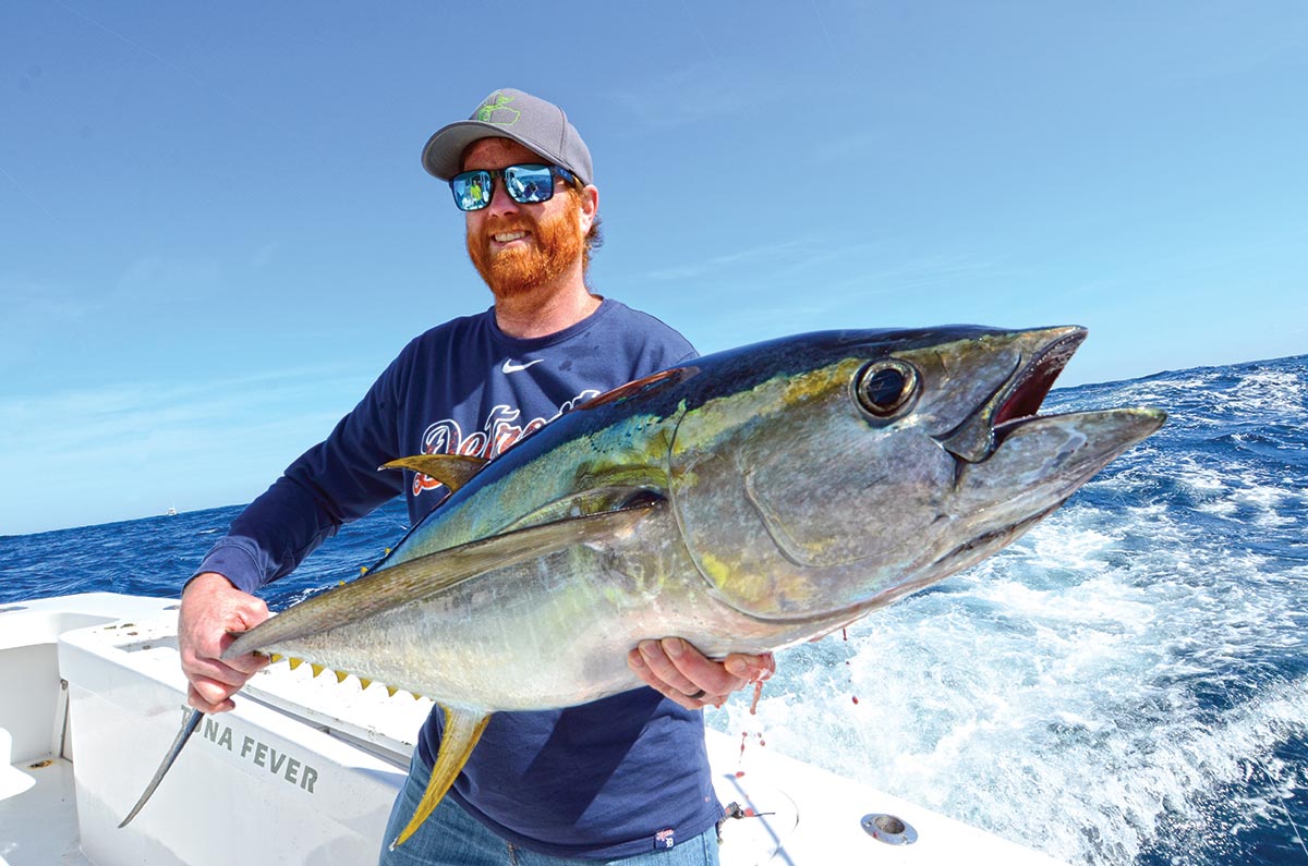Showing off a huge yellowfin tuna catch. 