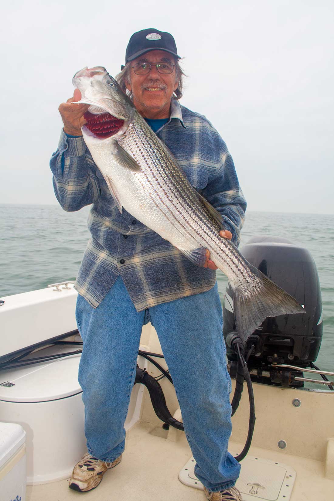 Mike Pizzolato with a striper caught at the Eights on a day when the wind and the current allowed small boats access. 