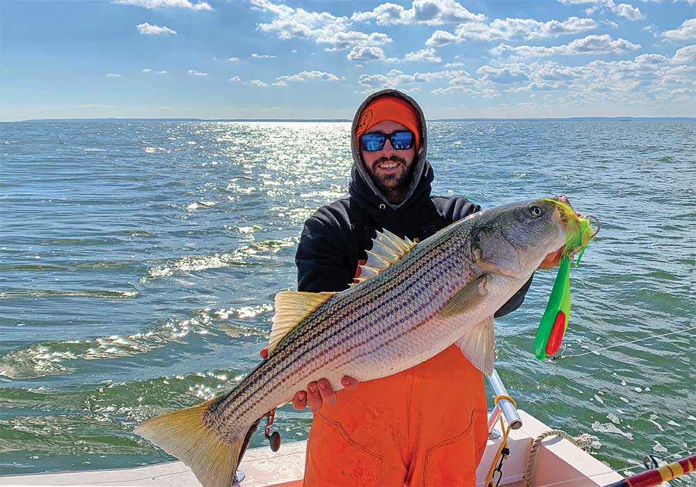 Doug Keeping shows off a nice striped bass caught on a spoon while trolling off the Jersey Shore. 