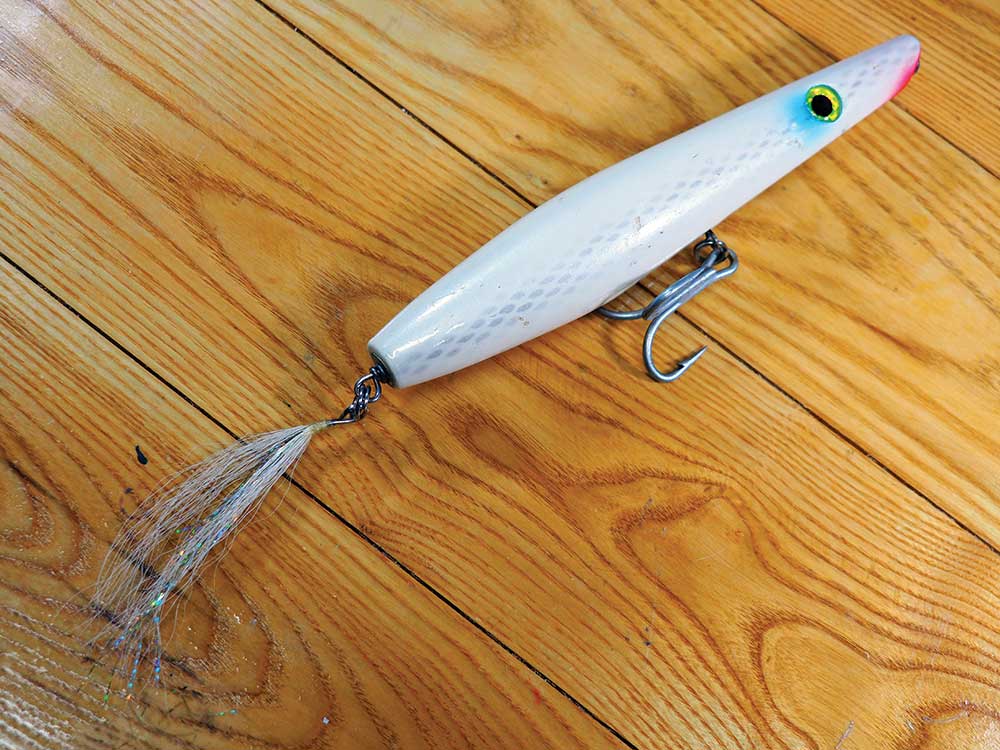 Consider dropping out the rear treble on a pencil and replacing it with a dressed flag attached with a split ring. This often allows for better casts and less damage to the fish while making for a more secure hook-up. (Photo by Toby Lapinski)